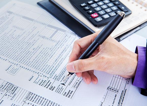 Woman with paperwork preparing Accounting Services in Norcross, Dunwoody, Roswell, GA, Duluth, GA, and Nearby Cities